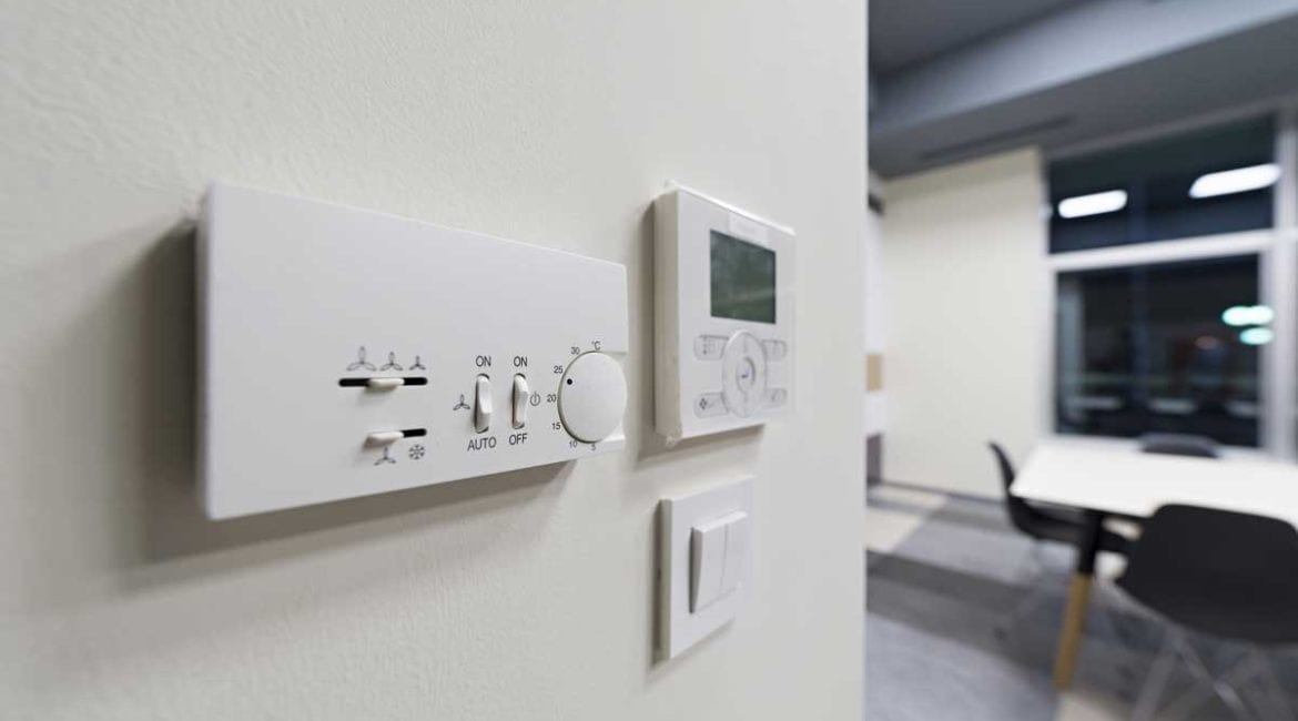 Programmable thermostat on a white wall