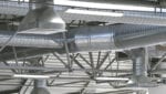 A network of metal ductwork in the ceiling of a commercial building