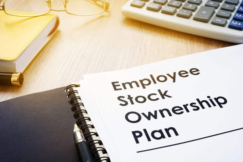 A photo of an open notebook that says “Employee Stock Ownership Plan”