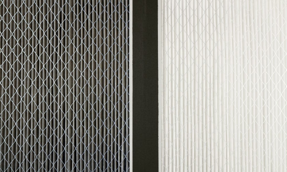 A dirty air filter and a clean air filter next to one another