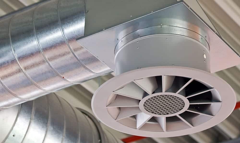 A closeup of an industrial fan at the end of a duct