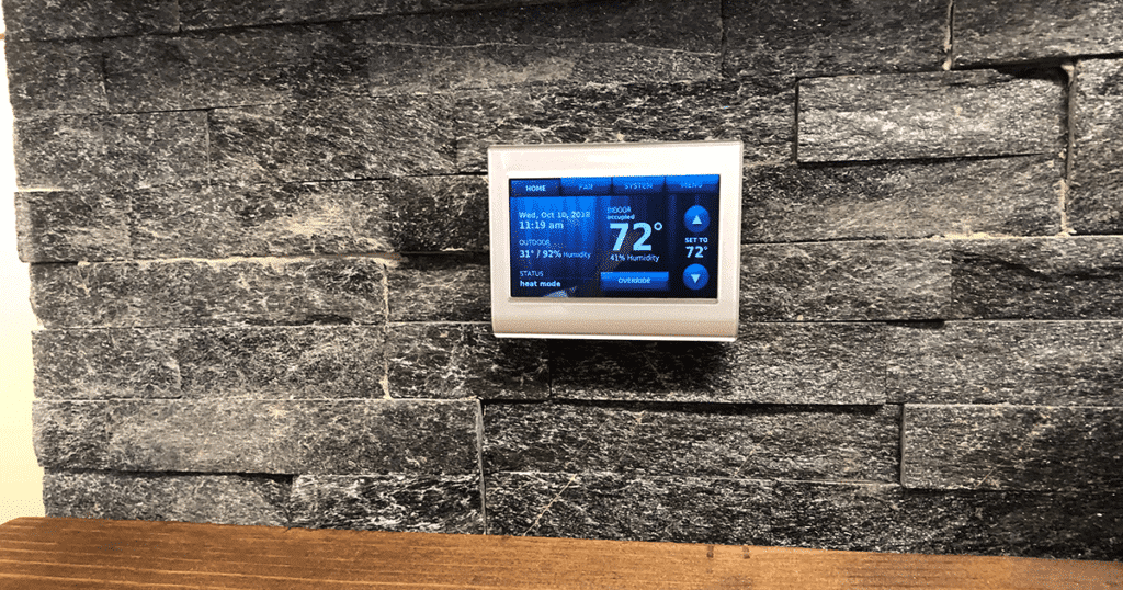 Programmable thermostat on wall
