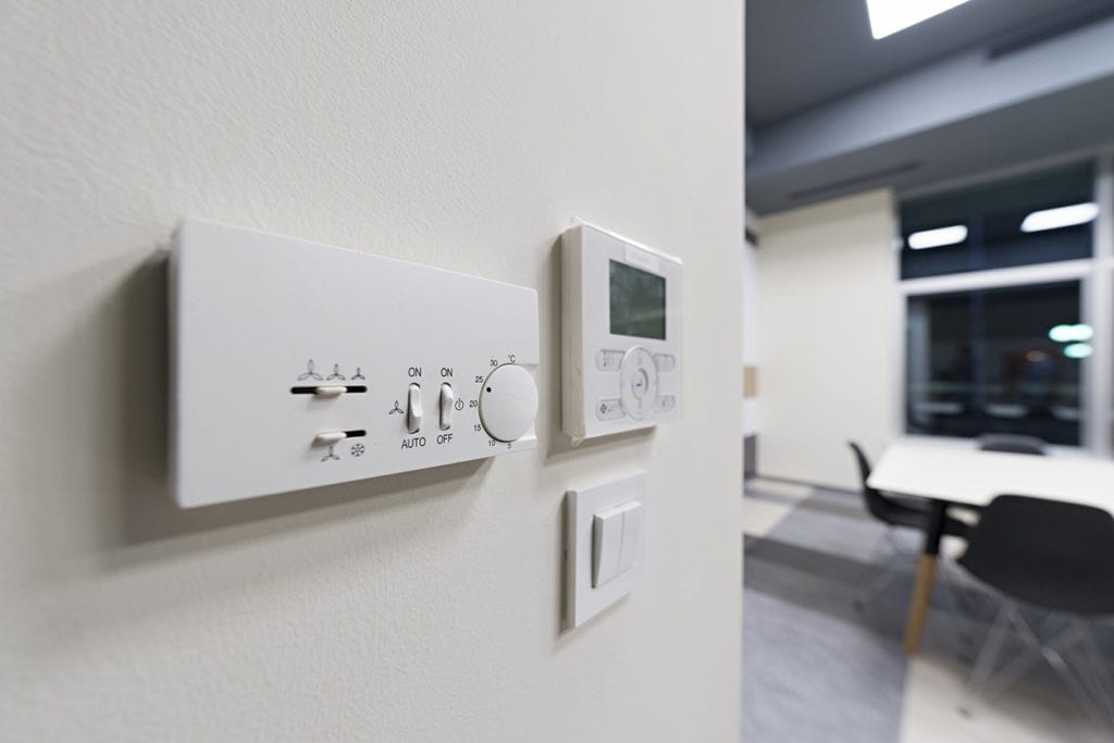 A thermostat mounted on a wall.