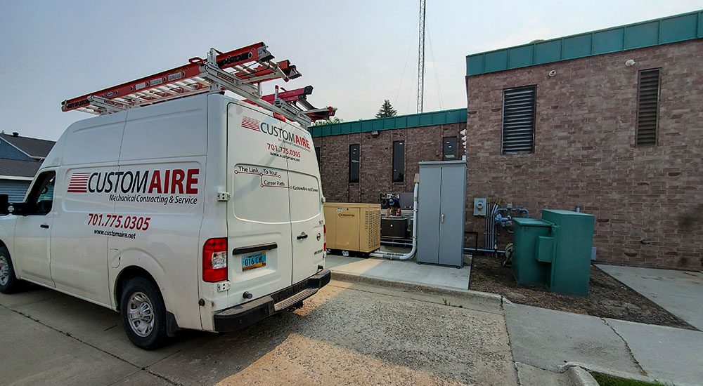 An exterior shot of a Custom Aire van parked at a business during a maintenance appointment